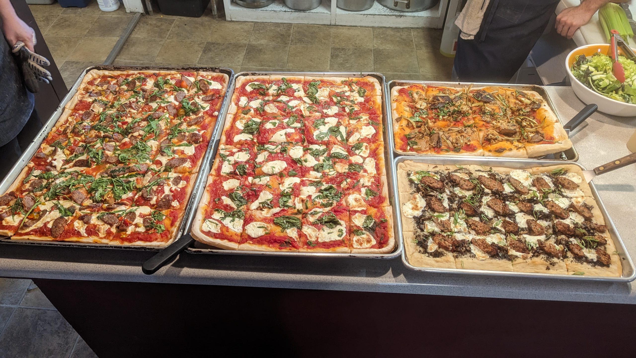 an array of delicious NMOP meals including pizza, miso soup, seafood and cake